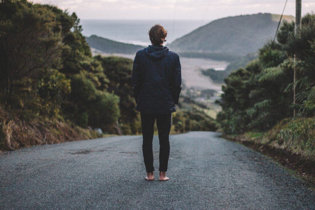 teen standing back to camera looking at mountains