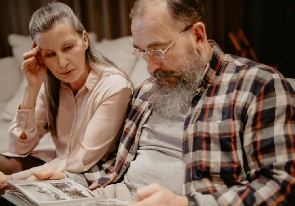 older couple looking at scrapbook