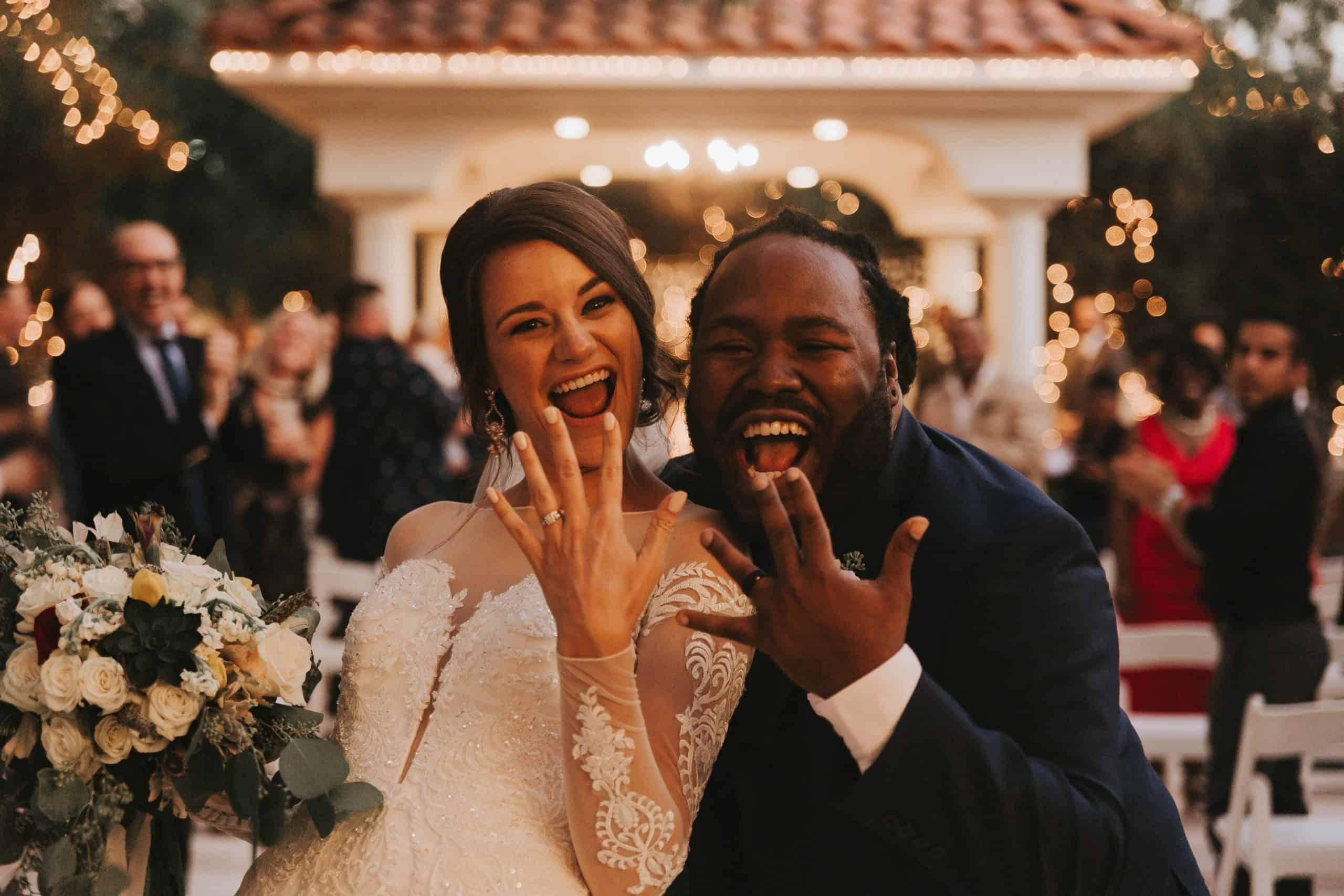 a newly married couple showing off their rings