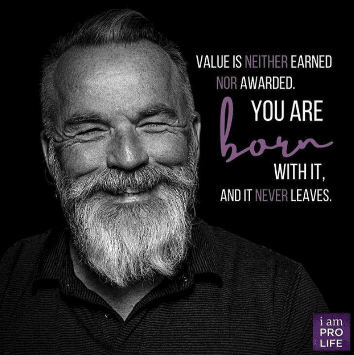 A man smiles next to a quote about value, because we valued even when socially isolated.