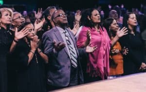 Photo of a group of Christians praying in church.
