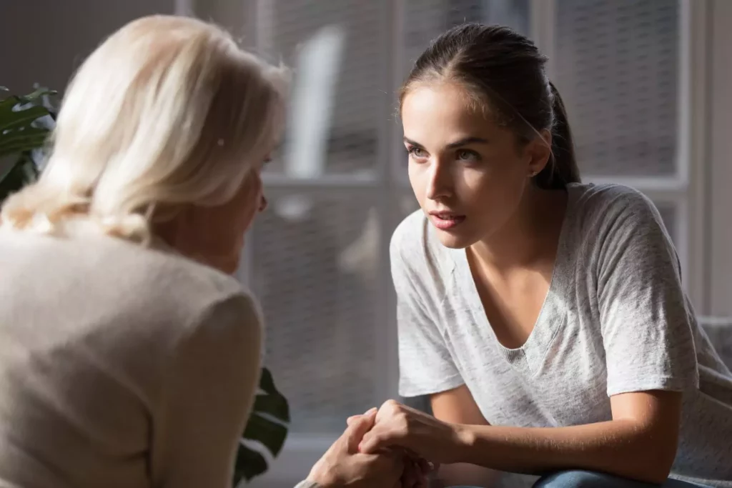 Bounce back kids happen in early adulthood. Young adult woman having a heart to heart talk with her mother.